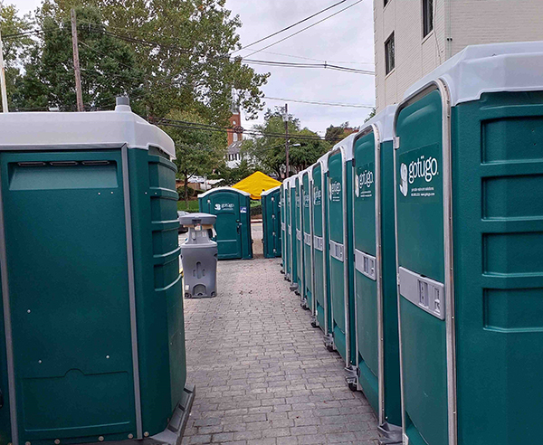 Row of portable toilets at an outdoor event